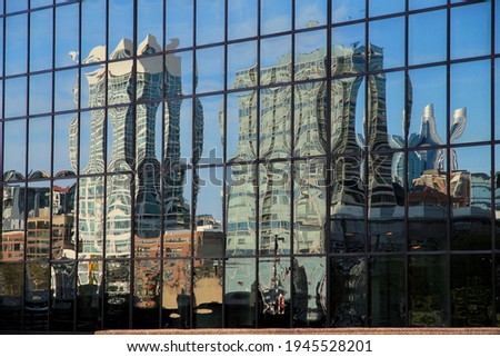 Milwaukee Skyline Reflected in Mirrored Building with Blue Sky 