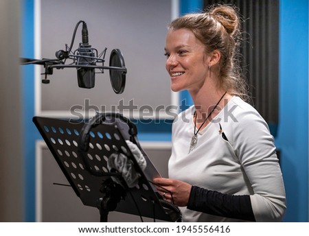 woman recording voice speech, voiceover and singing in studio