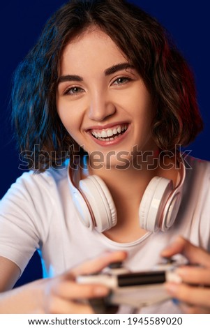 happy curly involved gamer girl playing video games