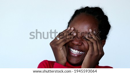 Black girl laughing uncontrollably. African teenager real life laugh and smile Royalty-Free Stock Photo #1945593064