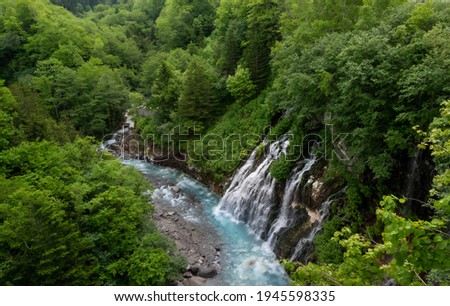 Scenery of shirahige's waterfall and Biei river. The water of this river flows into the blue pond at the downstream. Biei Hokkaido, Japan