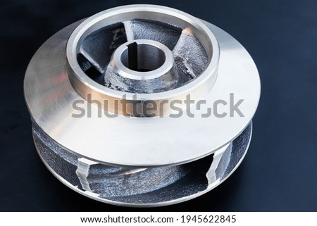New bronze impeller on a black background, top view. Royalty-Free Stock Photo #1945622845