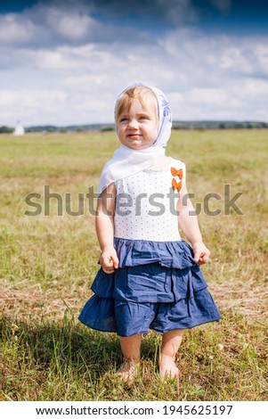 Portrait of   Russian baby in   summer meadow in   field