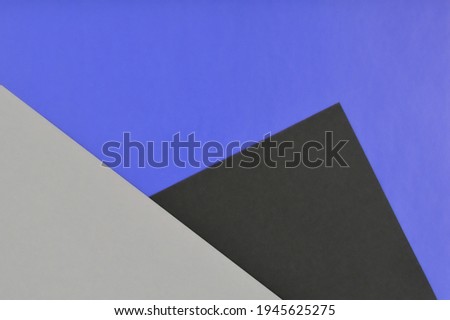 Abstract geometric paper  background with black blue and gray triangles
