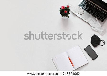 This photo is good for text. In this picture you find notebook, phone, small rose and others things. Point this picture is home office or study at home.