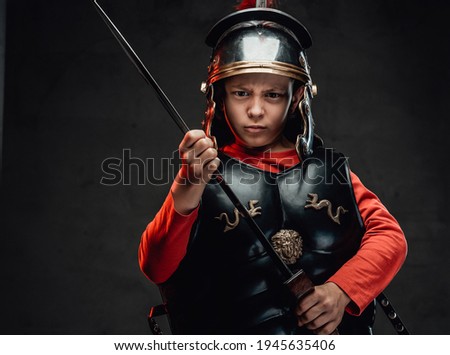 Angry roman boy warrior with sword and red cape