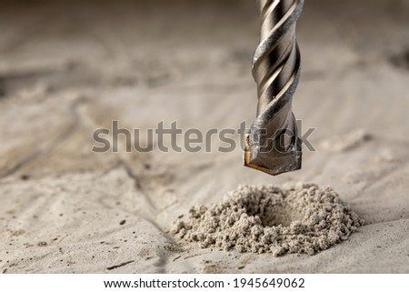 Drill bit for drilling concrete masonry or stone. Metal work industry. Royalty-Free Stock Photo #1945649062
