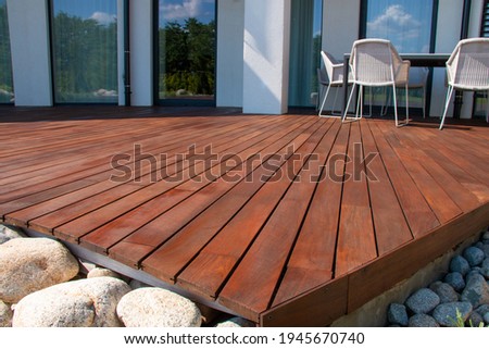 Ipe wood deck, modern house design with wooden patio, low angle view of tropical hardwood decking Royalty-Free Stock Photo #1945670740