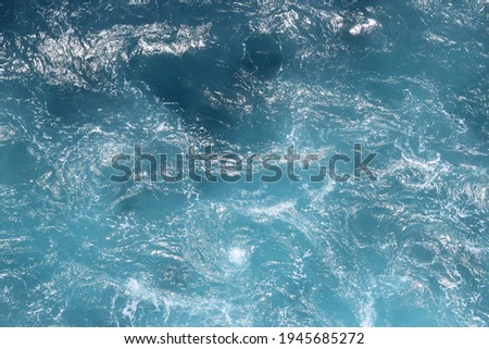 Bird's eye view of the ocean blue turquise water, from above. Background abstract water pattern