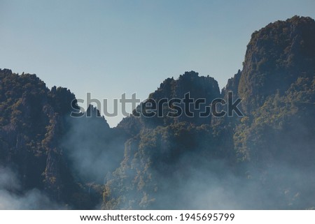 Landscape photography of karst mountains and their silhouettes, from the city of Vang Vieng, Laos, covered with forests formed by lush green tropical trees. Vientiane province.