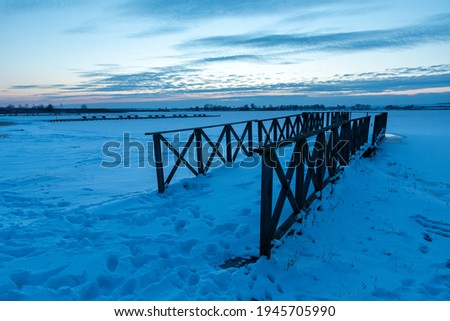 Wooden pier and a frozen lake after sunset, Zoltance, Lubelskie, Poland