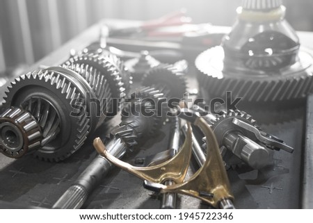 parts of an automotive manual transmission on a table in a car service. Close up Royalty-Free Stock Photo #1945722346