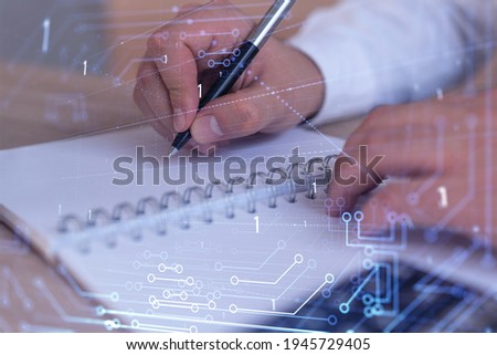 Hands writing down some ideas to create innovative software to change the world and provide a completely new service. Close up shot. Hologram tech graphs. Concept of Dev team. Formal wear.