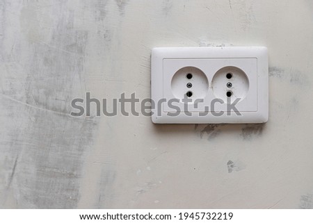 Double socket on a plastered plasterboard wall.