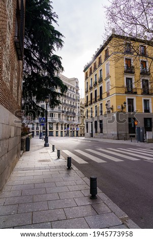 Madrid street with neoclassical buildings of different colors and typical balconies. Spain.