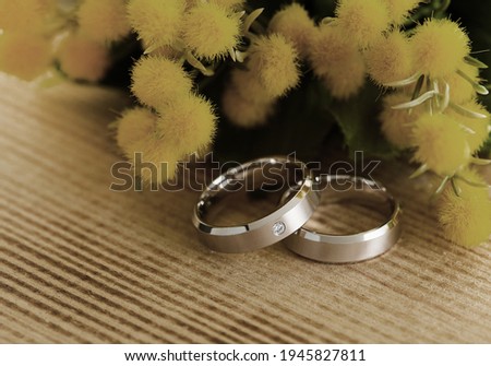 Silver wedding rings on a wooden background
