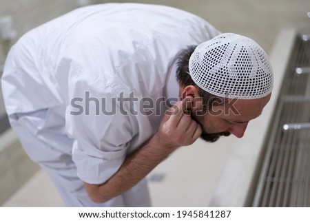 Muslim man taking ablution for prayer. Islamic Religious Rite Ceremony Of Ablution parts of body  Washing Royalty-Free Stock Photo #1945841287