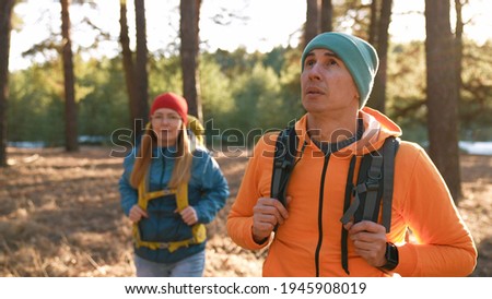 Teamwork. a group of hikers tourists walk through the forest with backpacks. team travel together business teamwork concept. man and woman hikers walking through woods. unity hiker in the woods