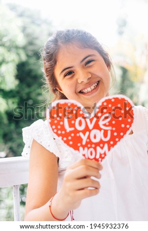 girl with an I love you mom sign. Concept of love. Happy mother's day.