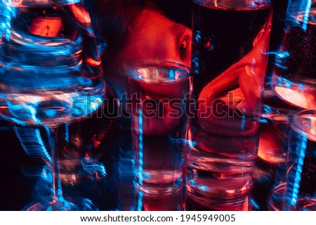 psychedelic portrait of a mad man schizophrenic looking through glasses of water