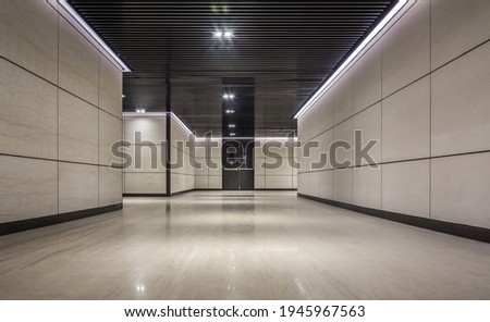 Empty underground corridor under commercial building Royalty-Free Stock Photo #1945967563