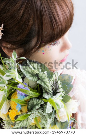 Up of a woman in a wedding dress with a bouquet