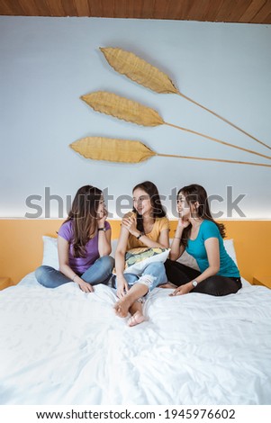 happy friendship on the bed. three girl friend having fun together