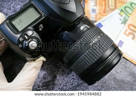 digital camera and money, store selling photographic equipment, pawnshop, closeup