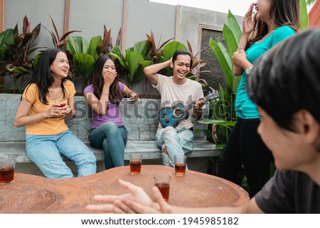 friends having fun while eating and drinking in the backyard - Happy people at garden party