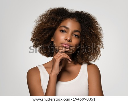African american woman afro hairstyle beauty smile in white t short overgray background studio female portrait