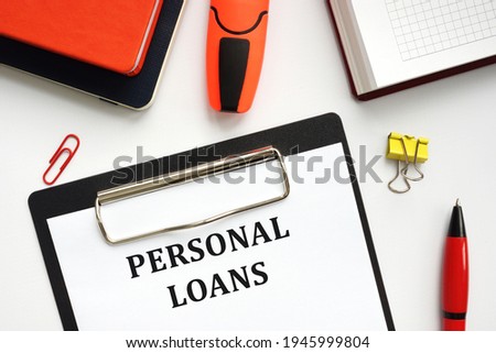 Business concept about PERSONAL LOANS with sign on the sheet. 
