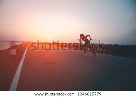 picture  movement young woman runner running on the road, The image is shaking due to movement.