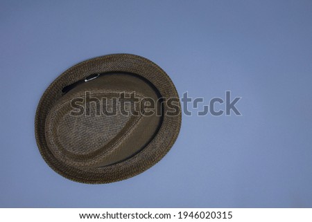 Beach and rustic straw hat on gray background