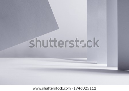 Abstract geometric white grey minimalist background with perspective of walls, stripes and flying paper in light and shadow as border, copy space.