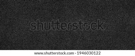 Black abstract background. Concrete wall finished with marble chips. Black stone background with copy space for design. Wide web banner.