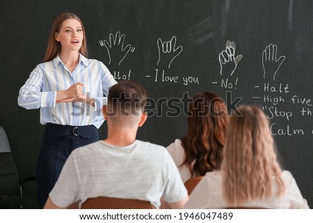 Teacher conducting courses for deaf mute people in classroom Royalty-Free Stock Photo #1946047489