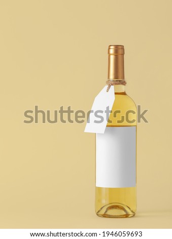 Bottle of wine with blank label on color background. Mockup for design