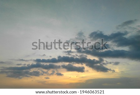 Sunset scenery view of colorful sky background with cumulus black clouds, beautiful weather conditions, nature photography