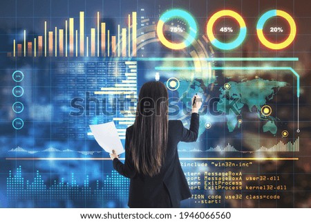 Big data concept with analyzing businesswoman with papers in hand and writing on digital interface with statistics indicators