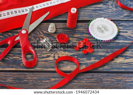 Needlework concept. Various sewing tools. Needles, scissors, threads on desk