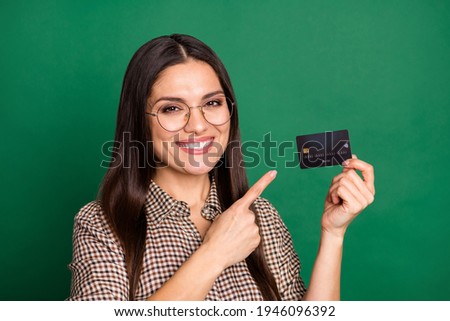 Photo of woman direct forefinger credit card wear spectacles checkered shirt isolated green color background