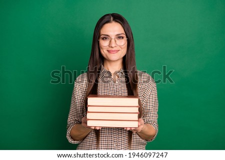 Photo of charming girl hold pile book wear spectacles checkered shirt isolated green color background