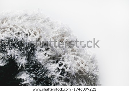 Knitted fabric with fringe on a decorative light background