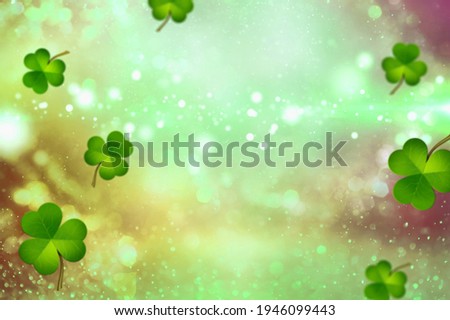 St. Patrick's Day abstract green background decorated with fresh shamrock leaves.