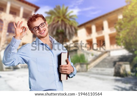 Young man showing ok hand sign and smiling
