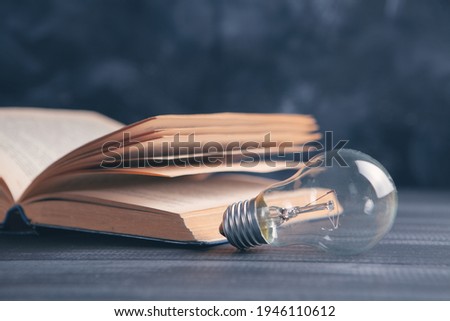knowledge and wisdom, light bulb on the book