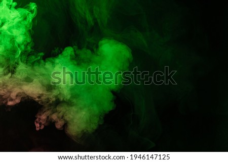 Green and pink steam on a black background. Copy space.