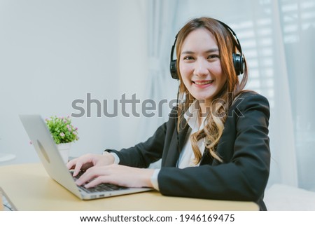 Asian young woman working in call center.