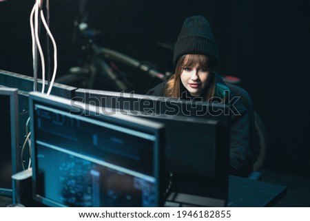 Nonconformist Teenage Hacker Girl Attacks Corporate Servers using Her Computer. Female hacker drinking coffee.