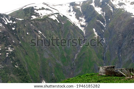 lost shack with mighty mountain backdrop in the caucasian mountains